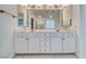 Bathroom featuring double sinks with an expansive vanity for ample storage and a decorative mirror at 3891 Sedgwick, Pahrump, NV 89061