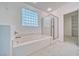 Bright bathroom featuring a soaking tub and separate shower with glass block window to allow natural light at 3891 Sedgwick, Pahrump, NV 89061