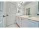 Bright bathroom featuring double sinks, white cabinetry, and a large mirror at 3891 Sedgwick, Pahrump, NV 89061