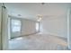 Spacious bedroom featuring large windows with curtains, neutral carpet and a ceiling fan at 3891 Sedgwick, Pahrump, NV 89061