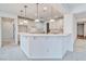 Open kitchen area offers white cabinets, breakfast bar and pendant lighting at 3891 Sedgwick, Pahrump, NV 89061