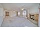 Spacious living room with plush carpeting, a cozy fireplace, and lots of natural light at 3891 Sedgwick, Pahrump, NV 89061