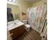 Bathroom with rainbow shower curtain, vanity and a well lit mirror at 4107 Macadamia Dr, Las Vegas, NV 89115