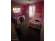Vibrant bedroom with pink accents, desk and plenty of room to relax at 4107 Macadamia Dr, Las Vegas, NV 89115