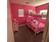 Charming bedroom with bright pink walls, bunk beds and two windows at 4107 Macadamia Dr, Las Vegas, NV 89115