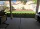 Covered patio view of the manicured backyard featuring artificial turf and a landscaped brick planter at 4107 Macadamia Dr, Las Vegas, NV 89115