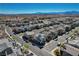 A high-angle, wide shot showcasing a well-planned community layout with uniform housing and ample street space at 513 Founders Creek Ave, North Las Vegas, NV 89084