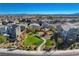 Neighborhood aerial view showcasing a playground, green spaces, and well-maintained homes under a clear blue sky at 513 Founders Creek Ave, North Las Vegas, NV 89084