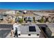 This aerial view shows homes near schools and mountain views of a modern community at 513 Founders Creek Ave, North Las Vegas, NV 89084