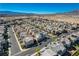 Overview of a large neighborhood displaying uniform rooftops and orderly streets under a vast blue sky at 513 Founders Creek Ave, North Las Vegas, NV 89084