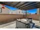 Comfortable back patio area with modern furniture and a shaded pergola, perfect for outdoor relaxation at 513 Founders Creek Ave, North Las Vegas, NV 89084