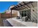 Comfortable back patio area with modern furniture and a shaded pergola, perfect for outdoor relaxation at 513 Founders Creek Ave, North Las Vegas, NV 89084