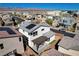 A modern home with solar panels boasts a pergola covered patio with mountain views at 513 Founders Creek Ave, North Las Vegas, NV 89084