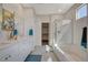 Bright bathroom featuring double sinks, tiled floors, and glass shower at 513 Founders Creek Ave, North Las Vegas, NV 89084