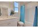 Bathroom featuring a single sink vanity, white cabinetry, and tiled shower at 513 Founders Creek Ave, North Las Vegas, NV 89084