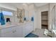 Bathroom featuring double sinks, white cabinetry, separate shower, and soaking tub at 513 Founders Creek Ave, North Las Vegas, NV 89084