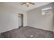 Neutral bedroom featuring plush carpet, closet and a ceiling fan at 513 Founders Creek Ave, North Las Vegas, NV 89084