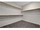 Walk-in closet featuring built-in shelving, and gray carpeting at 513 Founders Creek Ave, North Las Vegas, NV 89084