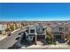 An aerial view shows a modern two-story home with a two-car garage in a suburban neighborhood with mountain views at 513 Founders Creek Ave, North Las Vegas, NV 89084