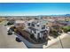 An aerial view showcases a modern two-story home with desert landscaping in a suburban neighborhood with mountain views at 513 Founders Creek Ave, North Las Vegas, NV 89084