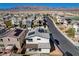 Aerial view of a two-story home featuring solar panels and modern architectural design at 513 Founders Creek Ave, North Las Vegas, NV 89084