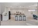 Bright kitchen featuring granite countertops, stainless steel appliances, and a breakfast bar with modern stools at 513 Founders Creek Ave, North Las Vegas, NV 89084