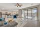 Bright living room featuring a modern ceiling fan, stylish furniture, and sliding doors to the backyard patio at 513 Founders Creek Ave, North Las Vegas, NV 89084