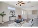 A modern living room boasting a sleek table, a potted plant, and a comfortable gray sofa at 513 Founders Creek Ave, North Las Vegas, NV 89084