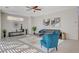 Bright living room featuring neutral walls, tile flooring, a modern sofa and an abundance of natural light at 513 Founders Creek Ave, North Las Vegas, NV 89084