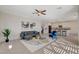 Open-concept living room with tile flooring, neutral walls, modern décor, and access to the kitchen at 513 Founders Creek Ave, North Las Vegas, NV 89084