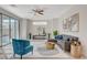 Bright living room featuring neutral walls, tile flooring, a modern sofa and an abundance of natural light at 513 Founders Creek Ave, North Las Vegas, NV 89084