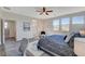 Bright main bedroom showcasing the bed and ensuite bathroom entrance, and ample natural light at 513 Founders Creek Ave, North Las Vegas, NV 89084