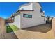 Well-maintained side yard featuring gravel, artificial grass and a privacy fence with access gate at 513 Founders Creek Ave, North Las Vegas, NV 89084