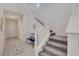 Bright staircase with carpeted steps and white railings ascending to the upper level at 513 Founders Creek Ave, North Las Vegas, NV 89084
