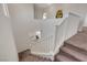 Carpeted staircase with white railing offers view of entry and living space below at 513 Founders Creek Ave, North Las Vegas, NV 89084