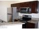 Updated kitchen with granite counters, stainless appliances, and wooden cabinets at 5130 S Jones Blvd # 108, Las Vegas, NV 89118