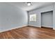 Bright bedroom features sleek hardwood floors, a ceiling fan, and ample natural light from a large window at 5162 S Jones Blvd # 106, Las Vegas, NV 89118