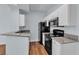 Efficient kitchen space with granite countertops, black appliances, and wood-look flooring at 5162 S Jones Blvd # 106, Las Vegas, NV 89118