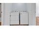 Laundry area has side by side washer and dryer, hardwood floors and white walls at 5162 S Jones Blvd # 106, Las Vegas, NV 89118