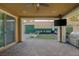 Covered patio includes ceiling fan, lights, TV and built in grill, perfect for outdoor entertaining at 6021 Vista Clara St, Las Vegas, NV 89148