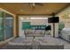 Digitally enhanced covered patio includes ceiling fan, lights, furniture, TV and built in grill at 6021 Vista Clara St, Las Vegas, NV 89148