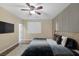 Bedroom featuring wood floors, neutral walls and a contemporary feature wall illuminated by a ceiling fan at 6021 Vista Clara St, Las Vegas, NV 89148