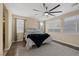 Bright bedroom featuring hardwood floors, a ceiling fan, and two windows bringing in natural light at 6021 Vista Clara St, Las Vegas, NV 89148