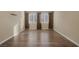 Spacious bedroom with hardwood flooring, neutral walls, and two windows bringing in natural light at 6021 Vista Clara St, Las Vegas, NV 89148