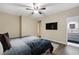 Bedroom featuring wood floors, neutral walls, ceiling fan and en-suite bathroom at 6021 Vista Clara St, Las Vegas, NV 89148