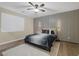 Bedroom featuring wood floors, neutral walls and a contemporary feature wall illuminated by a ceiling fan at 6021 Vista Clara St, Las Vegas, NV 89148