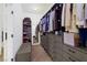 Walk-in closet featuring built-in shelves, drawers, ample storage space, and a full-length mirror at 6021 Vista Clara St, Las Vegas, NV 89148