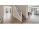 Open entryway with hardwood floors, a staircase with a white banister, and views into the living spaces at 6021 Vista Clara St, Las Vegas, NV 89148