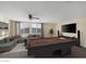 Upstairs game room featuring a pool table, modern sectional sofa, and large windows at 6021 Vista Clara St, Las Vegas, NV 89148