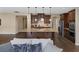 Kitchen with a granite island, wood cabinetry, and modern appliances, seamlessly connecting to the living area at 6021 Vista Clara St, Las Vegas, NV 89148